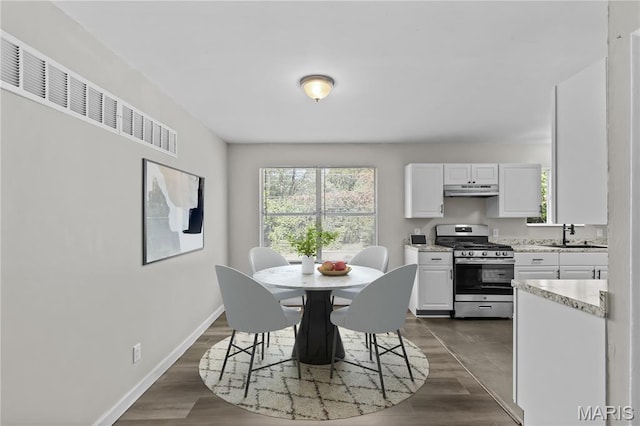 10411 Royal Dr, Saint Louis, MO 63136 - dining space with baseboards and dark wood-type flooring
