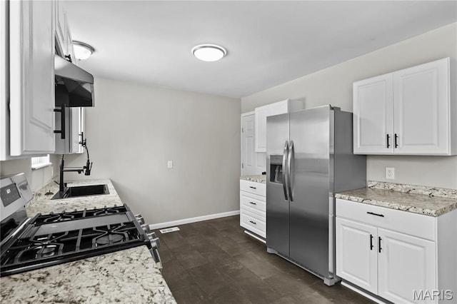 10411 Royal Dr, Saint Louis, MO 63136 - kitchen featuring appliances with stainless steel finishes, white cabinets, light stone countertops, and extractor fan