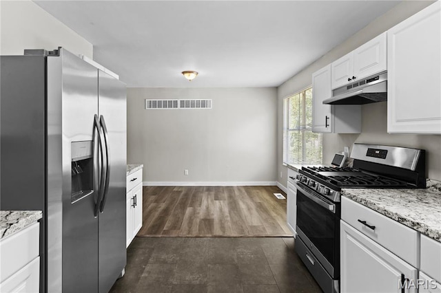 10411 Royal Dr, Saint Louis, MO 63136 - kitchen featuring stainless steel appliances, under cabinet range hood, white cabinets, and light stone countertops