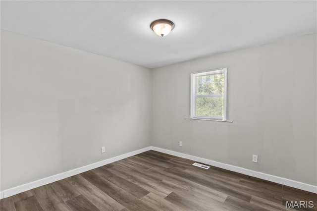 10411 Royal Dr, Saint Louis, MO 63136 - unfurnished room featuring dark wood-style floors and baseboards