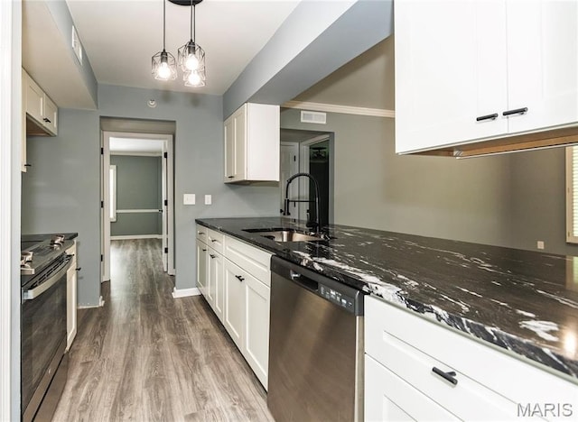 3624 Colonia Pl Unit B, Saint Louis, MO 63125 - kitchen featuring appliances with stainless steel finishes, dark stone counters, wood finished floors, and white cabinets