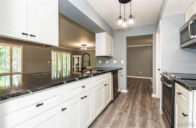 3624 Colonia Pl Unit B, Saint Louis, MO 63125 - kitchen with appliances with stainless steel finishes, white cabinetry, plenty of natural light, and wood finished floors