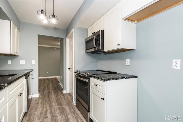 3624 Colonia Pl Unit B, Saint Louis, MO 63125 - kitchen featuring stainless steel appliances, dark wood-type flooring, white cabinets, and dark stone countertops