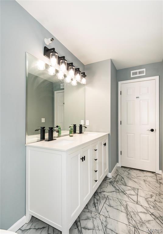 3624 Colonia Pl Unit B, Saint Louis, MO 63125 - bathroom featuring marble finish flooring and double vanity