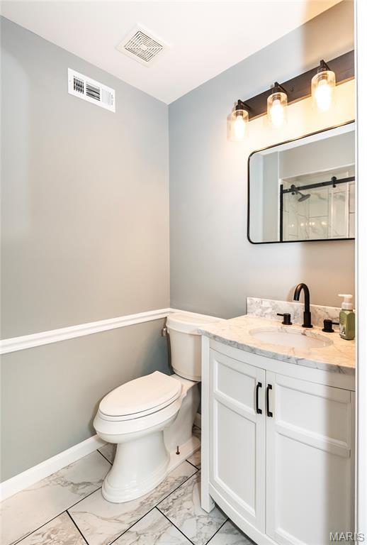 3624 Colonia Pl Unit B, Saint Louis, MO 63125 - bathroom with marble look tile flooring and vanity