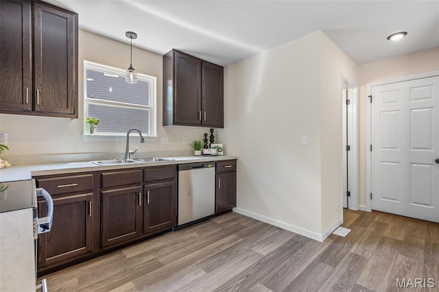 1917 Magnolia Way, Pevely, MO 63070 - kitchen featuring dishwasher, stove, light wood-style floors, dark brown cabinetry, and light countertops