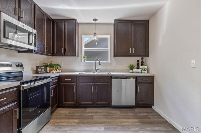 1917 Magnolia Way, Pevely, MO 63070 - kitchen featuring stainless steel appliances, dark brown cabinets, light countertops, and dark wood-style flooring