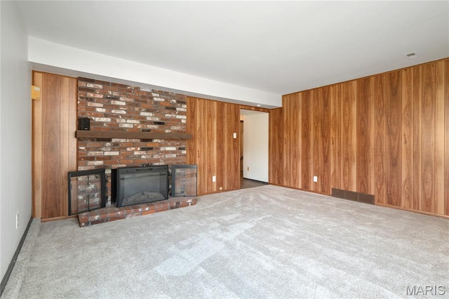2516 Westminister Dr, Saint Charles, MO 63301 - unfurnished living room with wood walls, carpet, and a brick fireplace