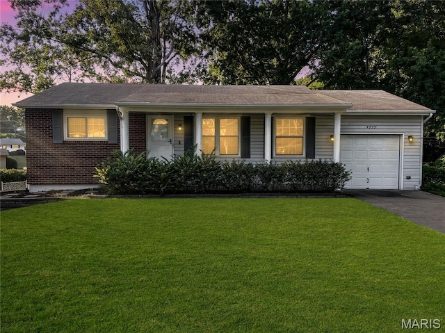 4253 Snelson Dr, Saint Louis, MO 63129 - single story home featuring a garage, a front yard, brick siding, a porch, and asphalt driveway