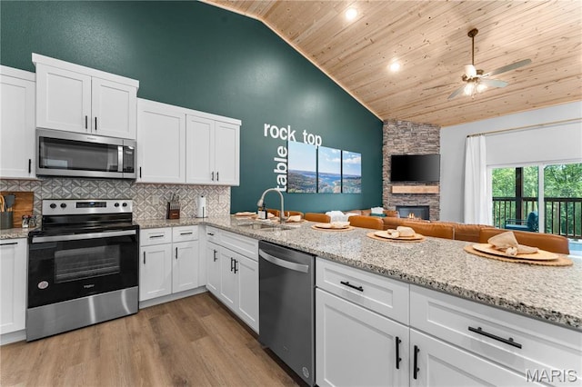 68 Meg Marie Ln Unit B, Branson, MO 65616 - kitchen with appliances with stainless steel finishes, wooden ceiling, white cabinetry, decorative backsplash, and wood finished floors