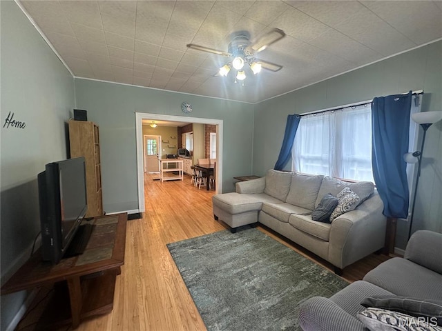 806 Pleasant St, Hannibal, MO 63401 - living room featuring a ceiling fan, wood finished floors, and crown molding