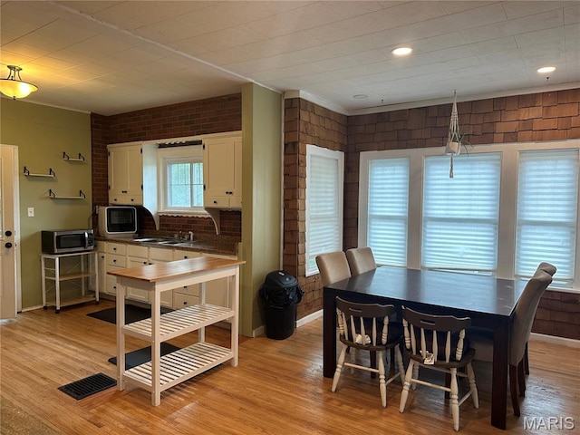 806 Pleasant St, Hannibal, MO 63401 - dining space featuring light wood finished floors and brick wall