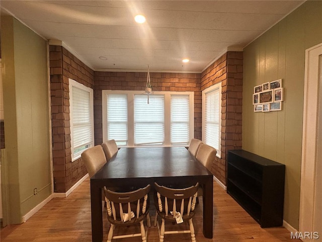 806 Pleasant St, Hannibal, MO 63401 - dining room with light wood-type flooring and wooden walls