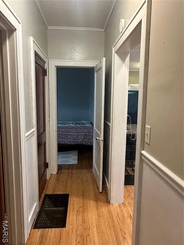 806 Pleasant St, Hannibal, MO 63401 - hallway featuring light wood-style floors and crown molding