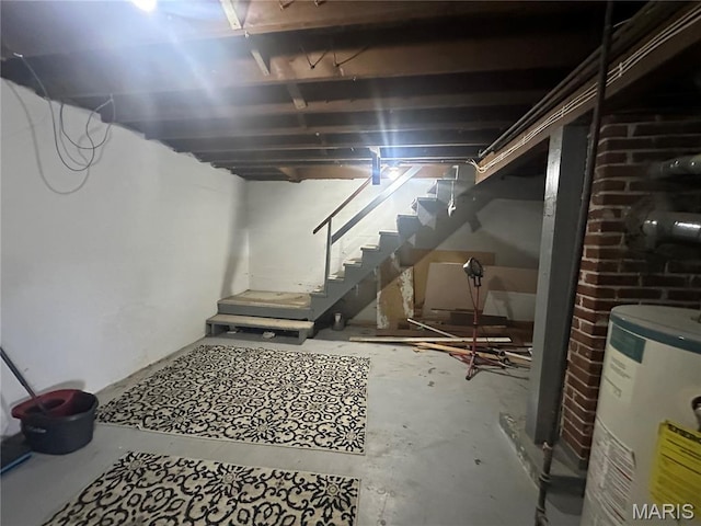 806 Pleasant St, Hannibal, MO 63401 - unfinished basement featuring electric water heater and stairs