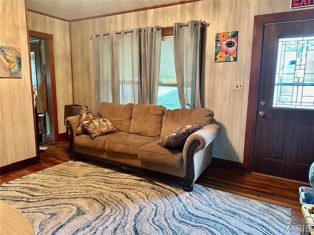 206 Cedar, Bertrand, MO 63823 - living room featuring wood finished floors, wooden walls, and crown molding