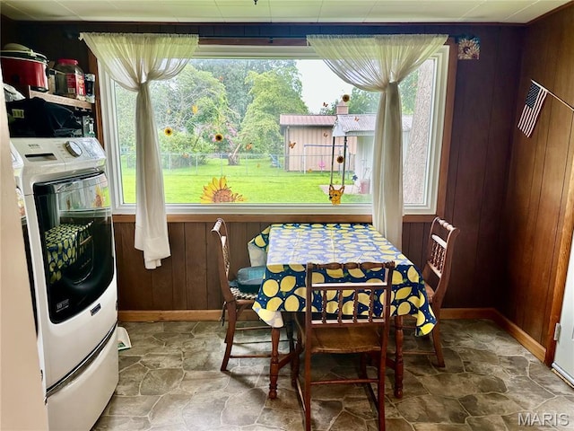 206 Cedar, Bertrand, MO 63823 - dining room featuring washer / clothes dryer, wood walls, and stone finish flooring