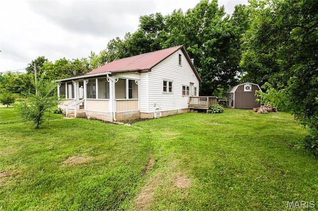 15902 County Road 7520, Newburg, MO 65550 - view of property exterior featuring a shed, a sunroom, a lawn, and a metal roof