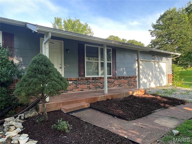 962 Martha Ave, Catawissa, MO 63015 - doorway to property with a porch, brick siding, and an attached garage