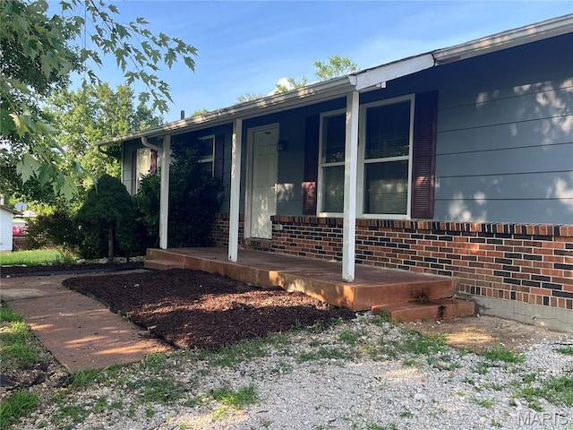 962 Martha Ave, Catawissa, MO 63015 - view of side of home with a porch and brick siding