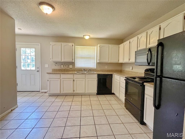 962 Martha Ave, Catawissa, MO 63015 - kitchen featuring black appliances, white cabinetry, light countertops, light tile patterned floors, and a textured ceiling