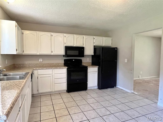 962 Martha Ave, Catawissa, MO 63015 - kitchen featuring black appliances, a textured ceiling, white cabinetry, light countertops, and light tile patterned floors