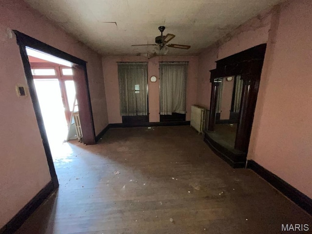 1063 Hornsby Ave, Saint Louis, MO 63147 - unfurnished living room featuring radiator and a ceiling fan