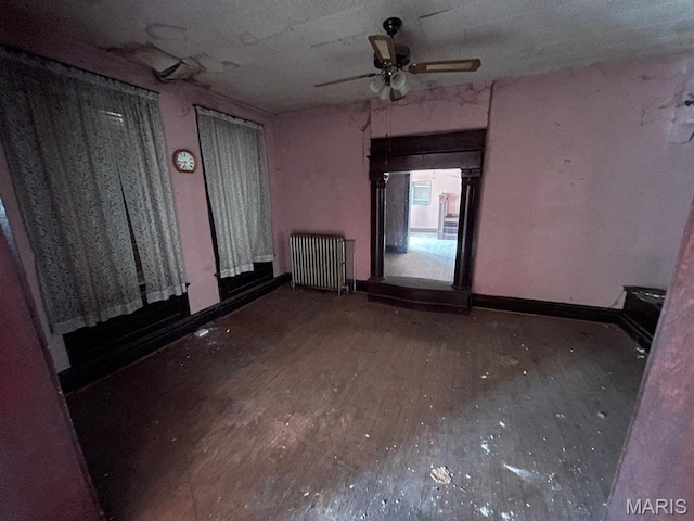 1063 Hornsby Ave, Saint Louis, MO 63147 - empty room with radiator heating unit, wood finished floors, and a ceiling fan