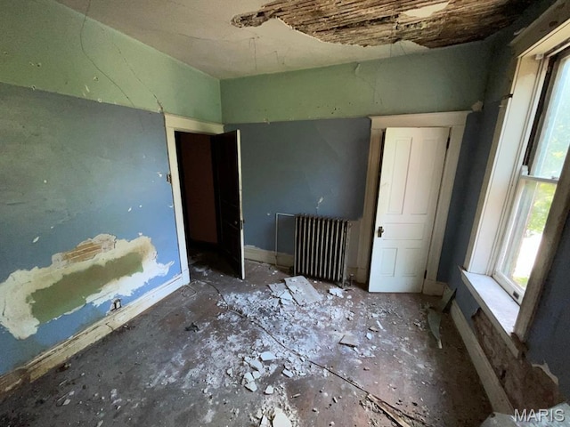 1063 Hornsby Ave, Saint Louis, MO 63147 - empty room with radiator heating unit and healthy amount of natural light