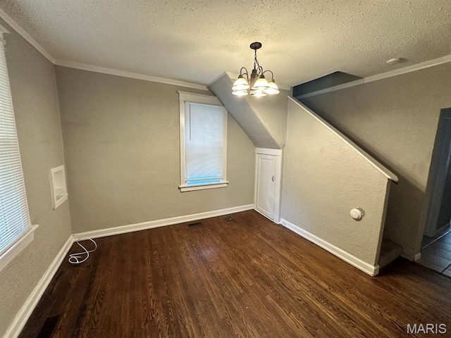 6624 Bartmer Ave, University City, MO 63130 - bonus room with dark wood-style floors, a textured ceiling, a chandelier, and a textured wall