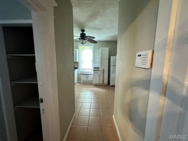 6624 Bartmer Ave, University City, MO 63130 - hall featuring tile patterned floors and a textured ceiling