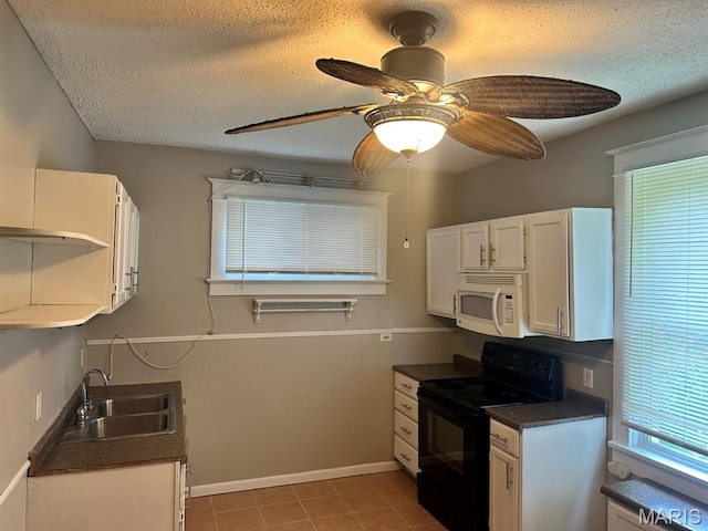 6624 Bartmer Ave, University City, MO 63130 - kitchen with white microwave, black electric range oven, dark countertops, a textured ceiling, and white cabinetry