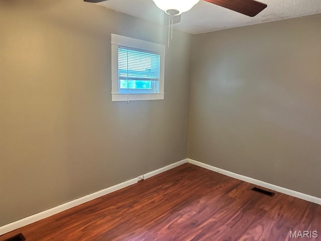 6624 Bartmer Ave, University City, MO 63130 - spare room with a ceiling fan, dark wood-type flooring, and a textured ceiling