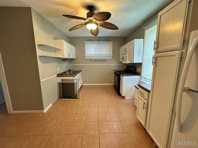 6624 Bartmer Ave, University City, MO 63130 - kitchen with white appliances, a textured ceiling, light tile patterned floors, dark countertops, and ceiling fan