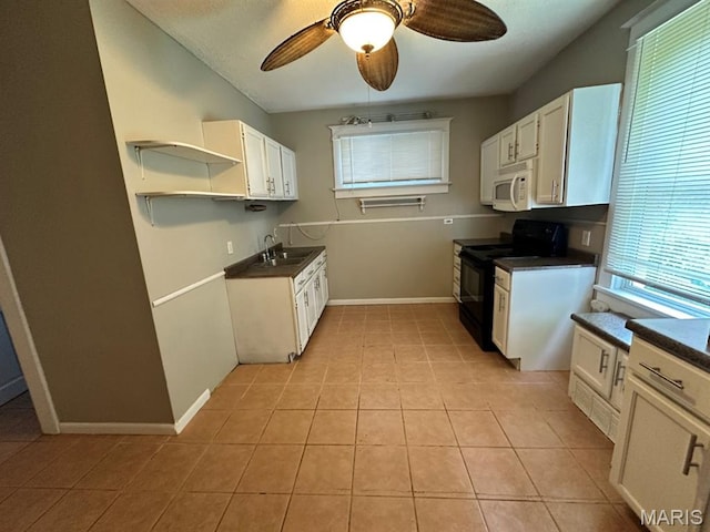 6624 Bartmer Ave, University City, MO 63130 - kitchen featuring electric range, white microwave, dark countertops, a ceiling fan, and open shelves