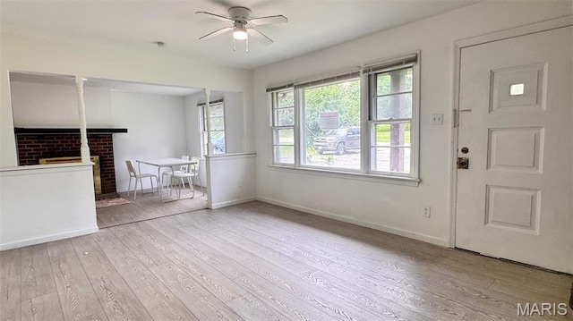 3400 Adie Rd, Saint Ann, MO 63074 - unfurnished living room with ceiling fan, wood finished floors, and a fireplace