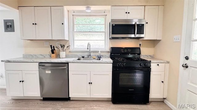 3400 Adie Rd, Saint Ann, MO 63074 - kitchen with appliances with stainless steel finishes and white cabinetry