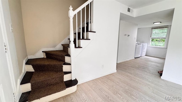 3400 Adie Rd, Saint Ann, MO 63074 - stairs with washing machine and dryer and wood finished floors