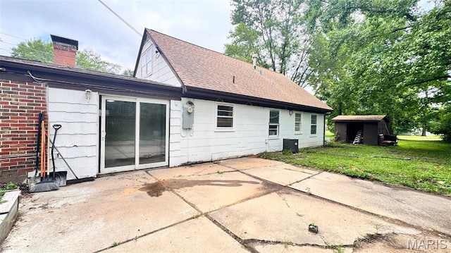 3400 Adie Rd, Saint Ann, MO 63074 - back of house with a patio, a yard, a shingled roof, and a chimney
