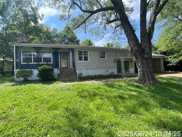 514 O Dell Ave, Richland, MO 65556 - view of front of home with brick siding, french doors, a front lawn, and a chimney
