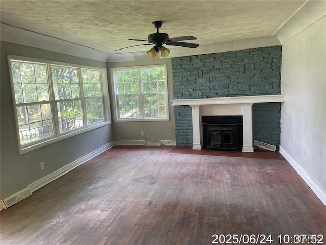 514 O Dell Ave, Richland, MO 65556 - unfurnished living room with ceiling fan, wood finished floors, a textured ceiling, and a fireplace
