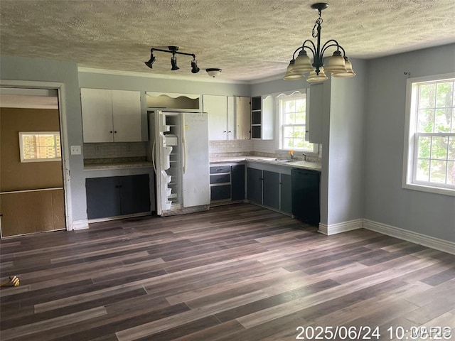 514 O Dell Ave, Richland, MO 65556 - kitchen featuring freestanding refrigerator, dishwasher, a textured ceiling, tasteful backsplash, and a chandelier