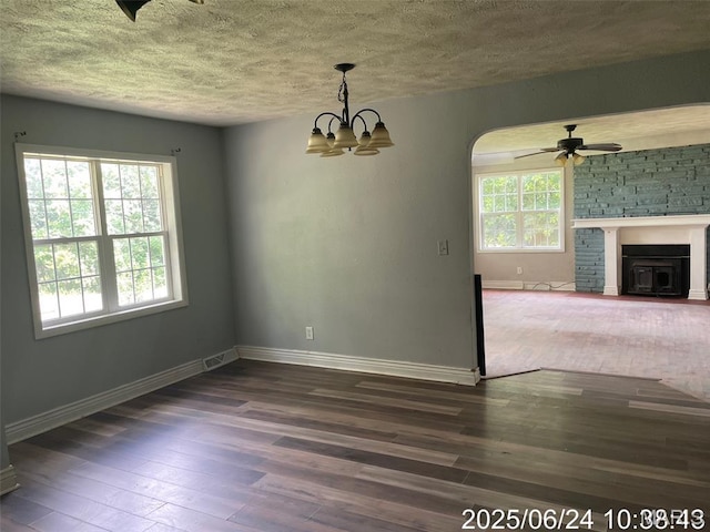 514 O Dell Ave, Richland, MO 65556 - unfurnished dining area featuring a textured ceiling, wood finished floors, ceiling fan, a chandelier, and arched walkways