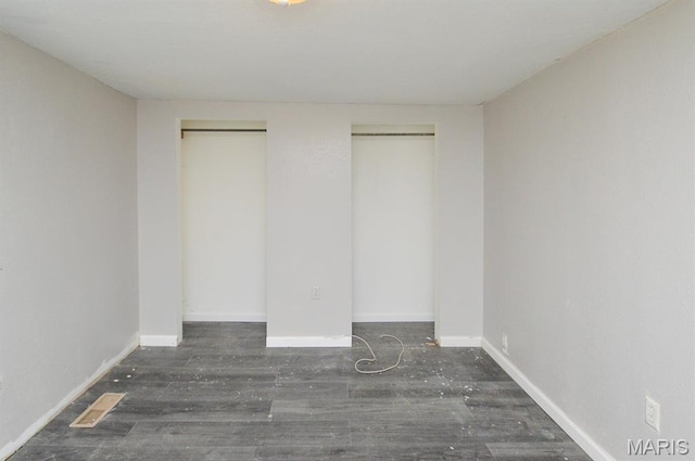 601 Mcbride Ave, Dupo, IL 62239 - unfurnished bedroom featuring multiple closets and wood finished floors