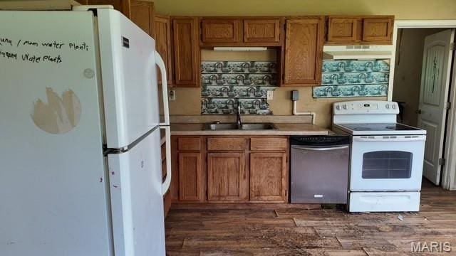 628 N Division St, Bonne Terre, MO 63628 - kitchen featuring white appliances, brown cabinets, dark wood-type flooring, and under cabinet range hood