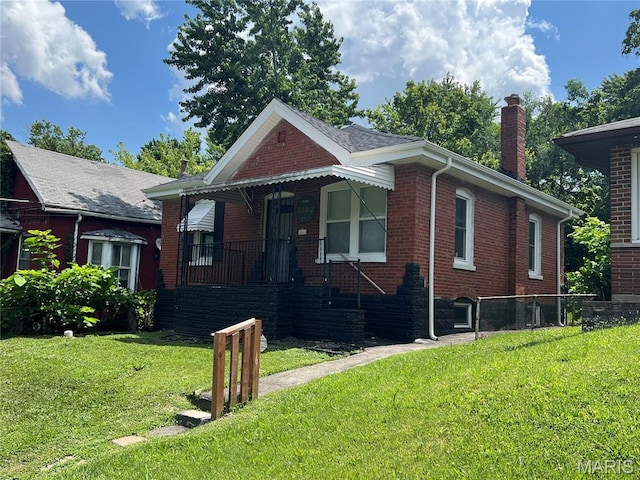 5502 Helen Ave, Saint Louis, MO 63136 - view of front of home with brick siding, a chimney, and a front yard