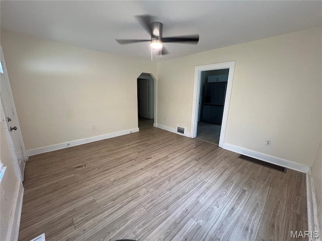 5502 Helen Ave, Saint Louis, MO 63136 - unfurnished room with ceiling fan, arched walkways, and wood finished floors