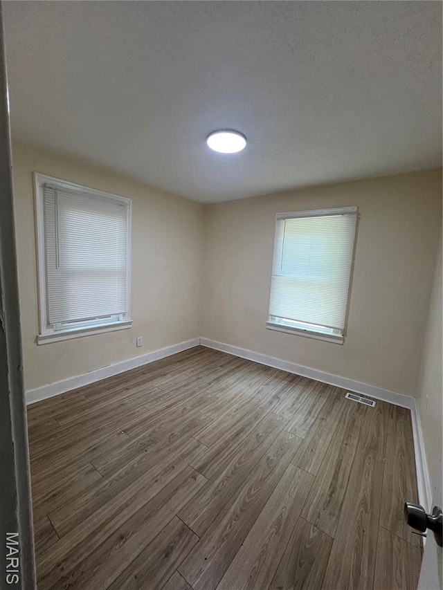 5502 Helen Ave, Saint Louis, MO 63136 - unfurnished room featuring wood finished floors and baseboards