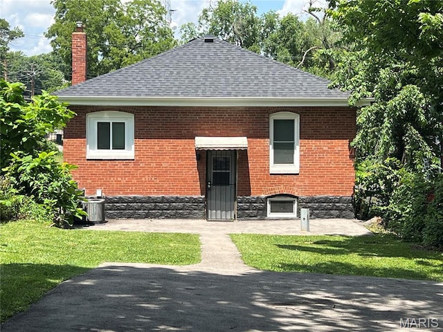 5502 Helen Ave, Saint Louis, MO 63136 - back of property with a chimney, a lawn, and brick siding