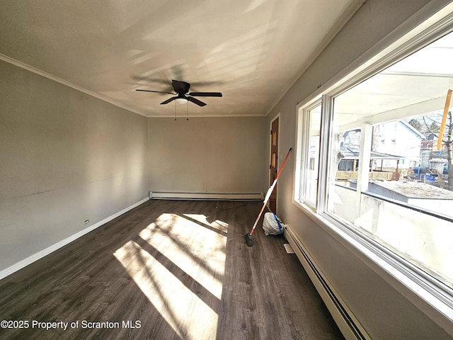 spare room with ornamental molding, dark hardwood / wood-style flooring, and a baseboard heating unit